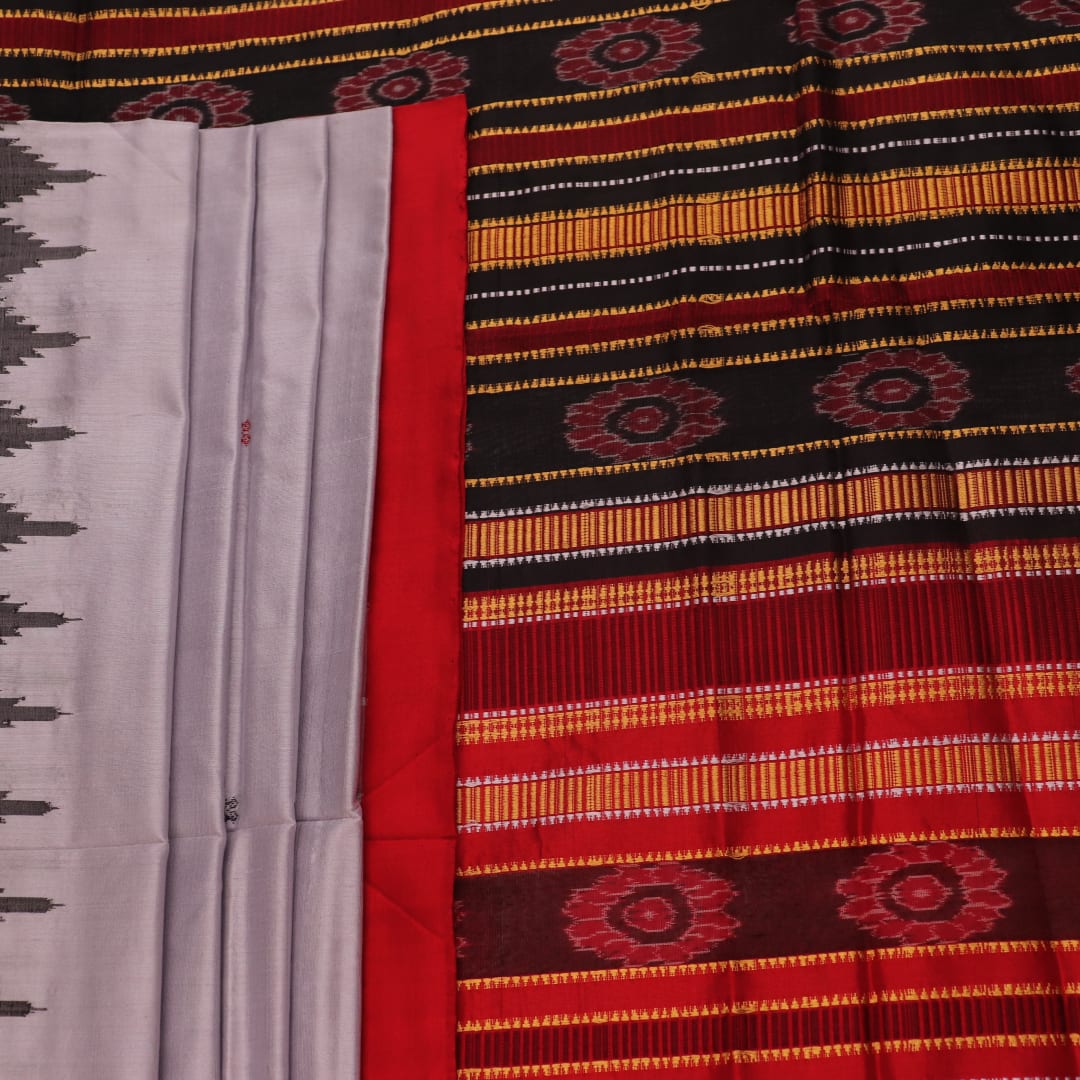 Close-up of grey and red Sambalpuri Silk saree fabric texture, highlighting butta pattern weave.