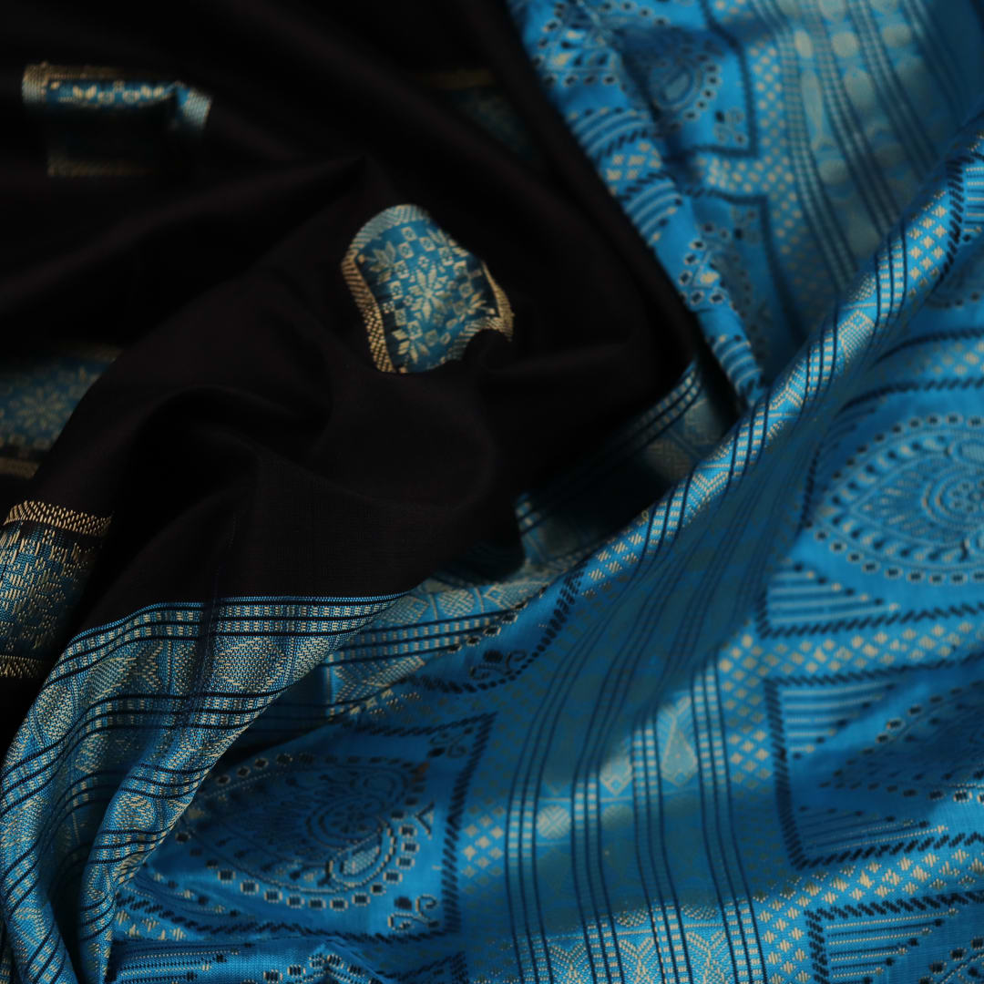 Close-up of Intricate Bomkai Silk Saree Fabric Texture in Black and Blue with Butta Pattern