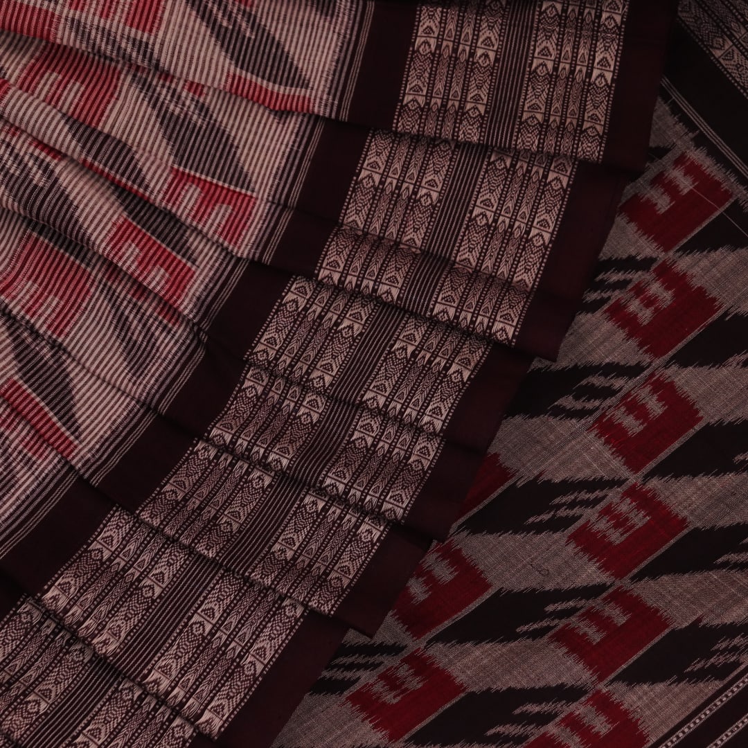 Grey and black cotton Sambalpuri saree with intricate motif pattern, displayed in full view.