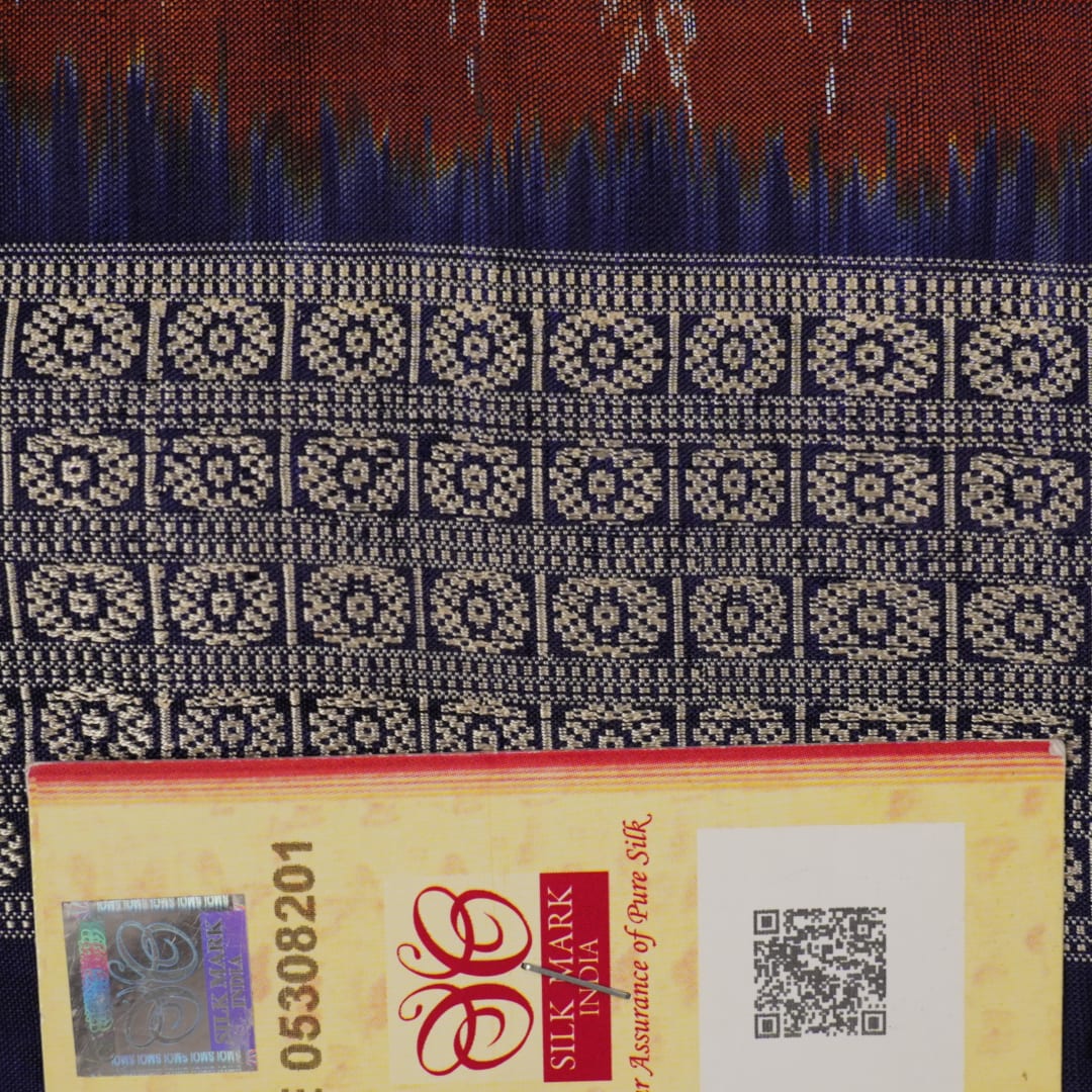 Close-up of the rich silk fabric texture of the Sambalpuri Saree, showing the intricate weave and slight sheen.