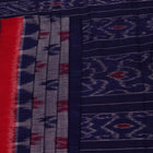 Blue Sambalpuri cotton saree with motifs, gracefully draped.