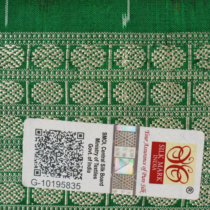 Close-up of the smooth, rich silk texture of the peach Sambalpuri saree with fine motifs.