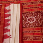 Khandua silk saree styled; white with red butta design, showcasing drape and overall look.