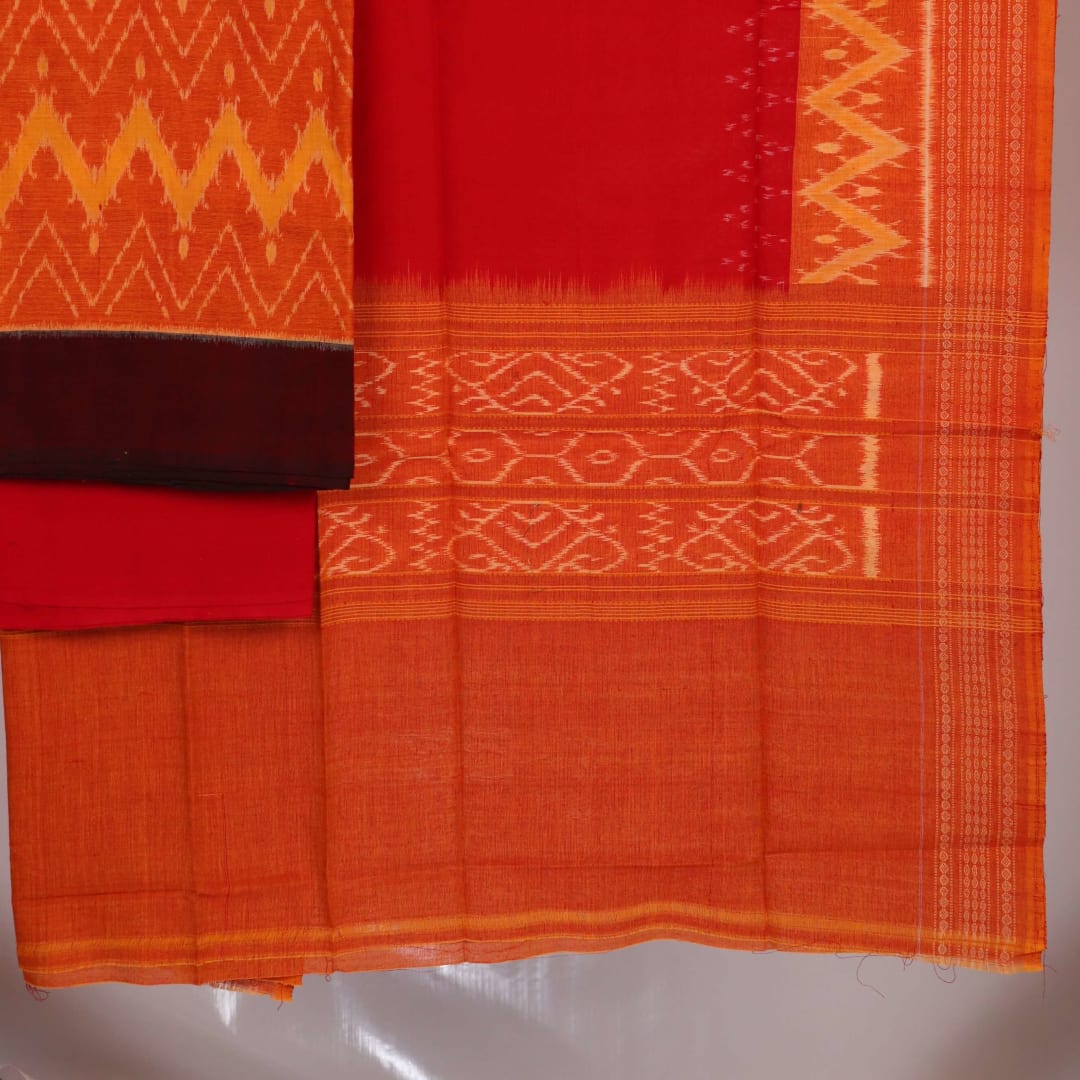 Close-up detail showcasing the traditional motifs in orange and red on cotton Sambalpuri dress material.