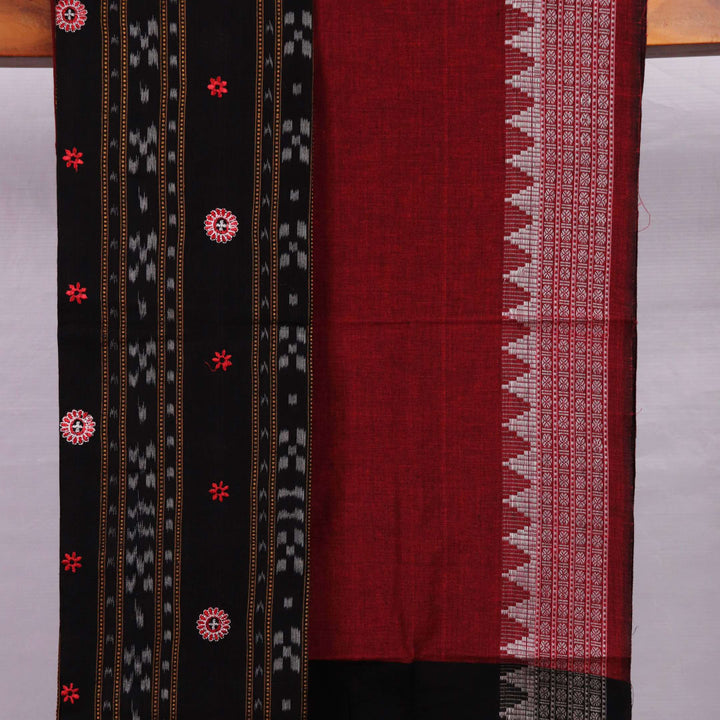 Fourth image in the series: Handloom cotton Sambalpuri dress material in black and maroon, featuring intricate motif patterns on the blouse piece.