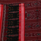 Black and red Sambalpuri cotton saree draped, showcasing its traditional motifs and elegant handloom texture.
