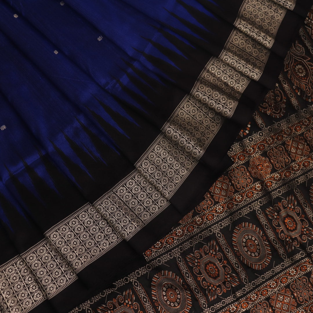 Close-up of the intricate woven texture of blue and black Bomkai silk saree with butta.