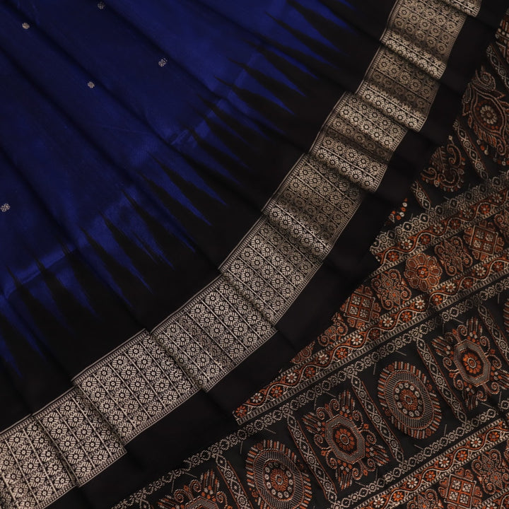 Close-up of the intricate woven texture of blue and black Bomkai silk saree with butta.