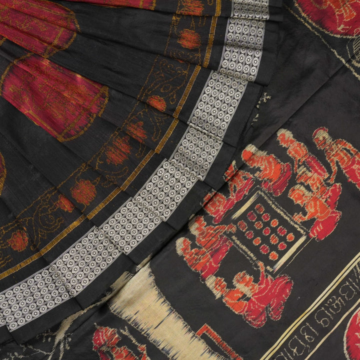 Close-up of the luxurious black Sambalpuri silk fabric, highlighting its rich texture and weave.