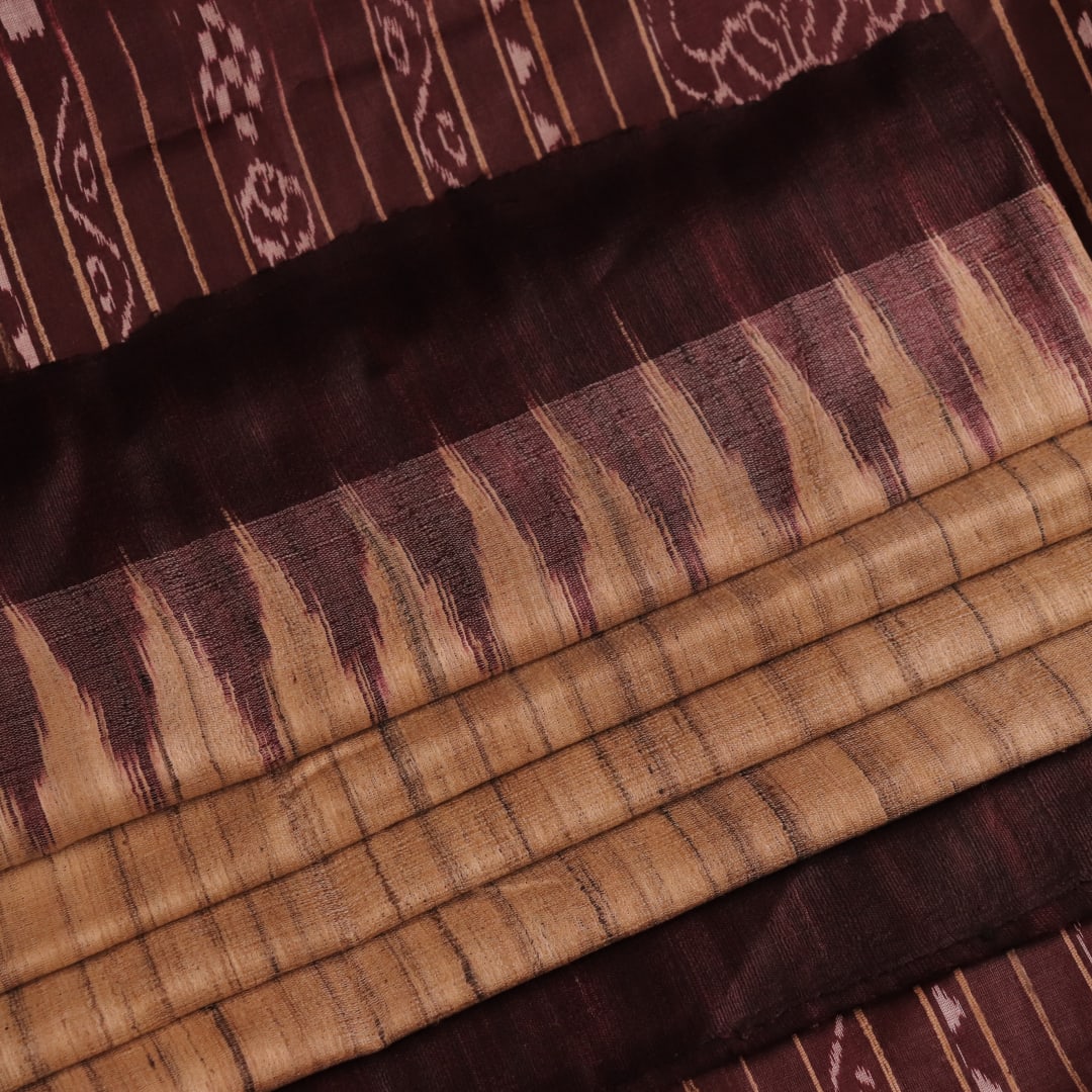 Close-up view of the textured Tussar Silk fabric of a Cream and Maroon Plain Tussar Saree