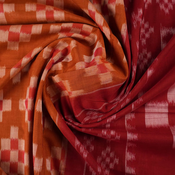 Full drape styling of a brown and maroon Sambalpuri cotton saree with motifs, modeled for elegant look.