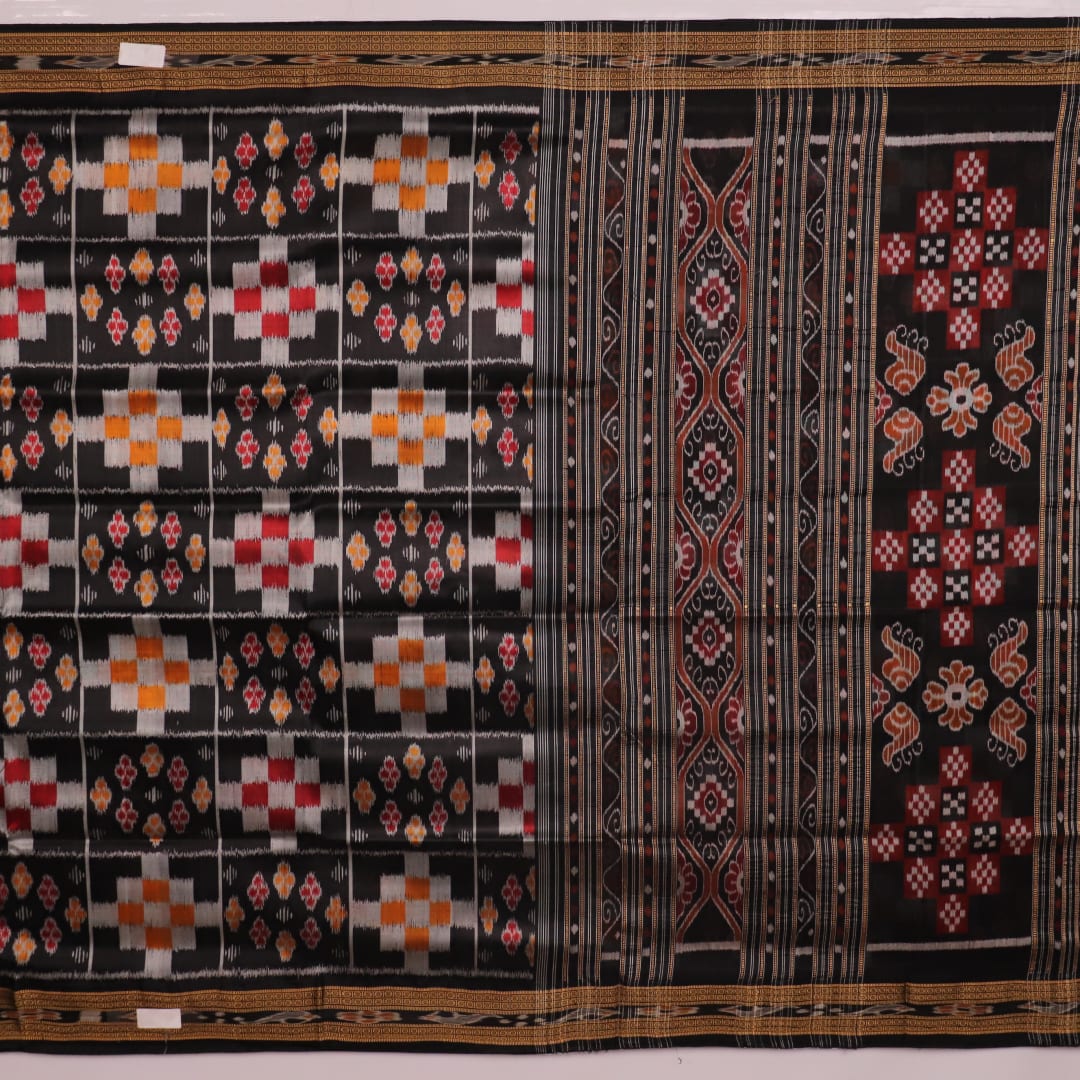 A woman elegantly draping a black silk Khandua Pasapalli saree with a detailed view of the drape and fall of the fabric.