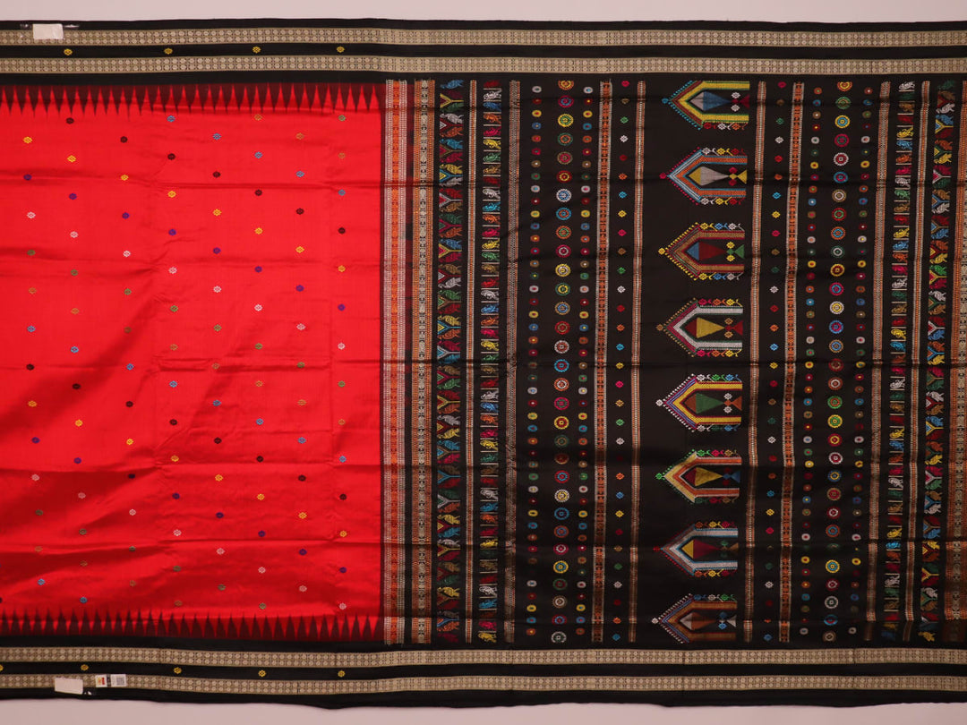 Close-up view of the soft and lustrous silk fabric texture of a Dolabedi red and black handloom saree with a butta pattern.