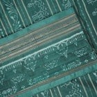 Close-up of green Sambalpuri silk fabric, showing its luxurious texture and fine handloom weave.