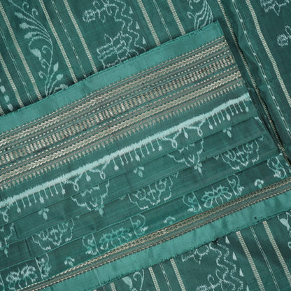Close-up of green Sambalpuri silk fabric, showing its luxurious texture and fine handloom weave.