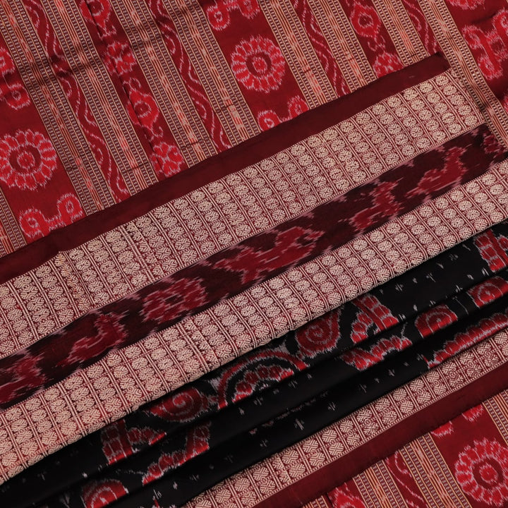 An approximately 150 cm wide handloom black silk Sambalpuri Saree with maroon motifs, captured in a close-up to depict its rich fabric texture.