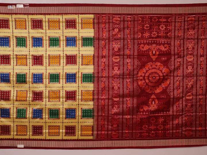 Close-up of multicolored Sambalpuri silk saree fabric texture showing intricate weave and maroon accents.