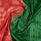 Close-up of the smooth, rich silk texture of the peach Sambalpuri saree with fine motifs.