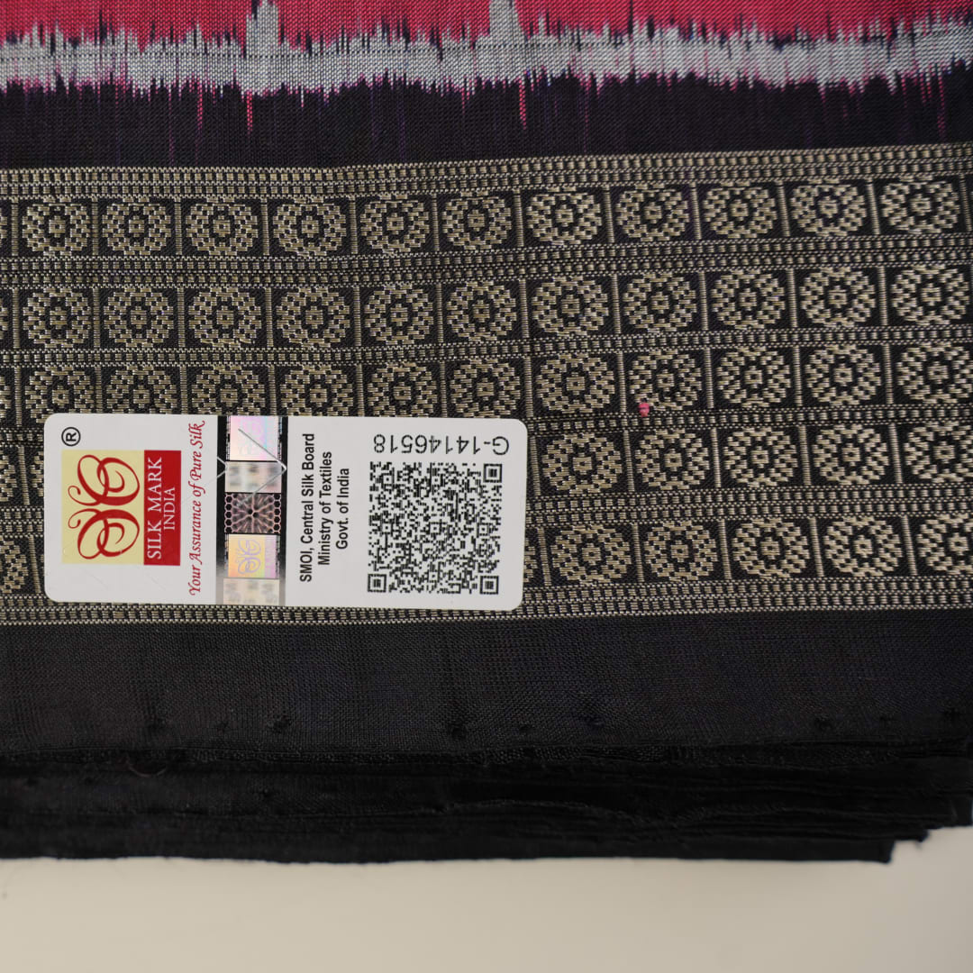 Detailed close-up of the maroon and black Sambalpuri silk saree's luxurious fabric texture and weave.