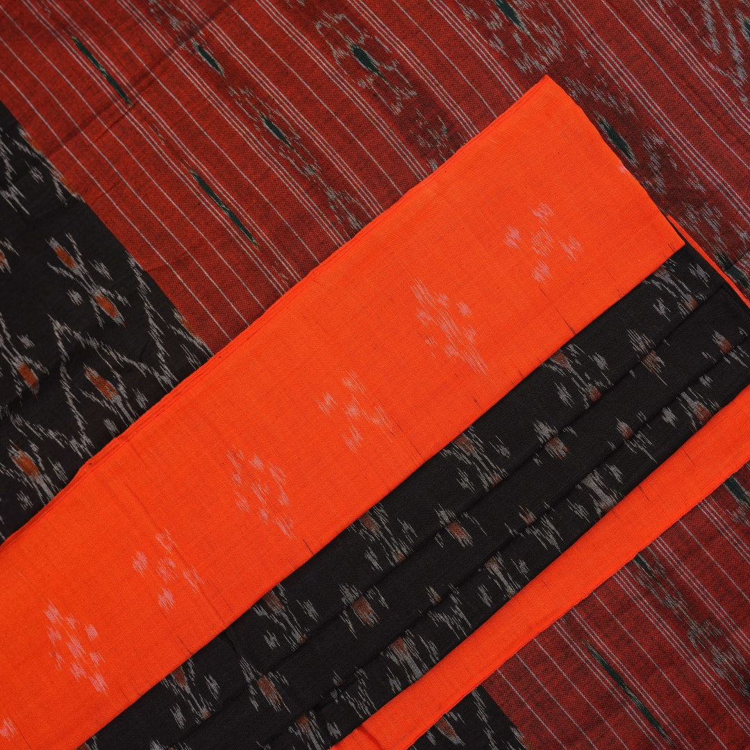 Elegant model styling of a black and orange Sambalpuri cotton saree showcasing the complete handloom look.