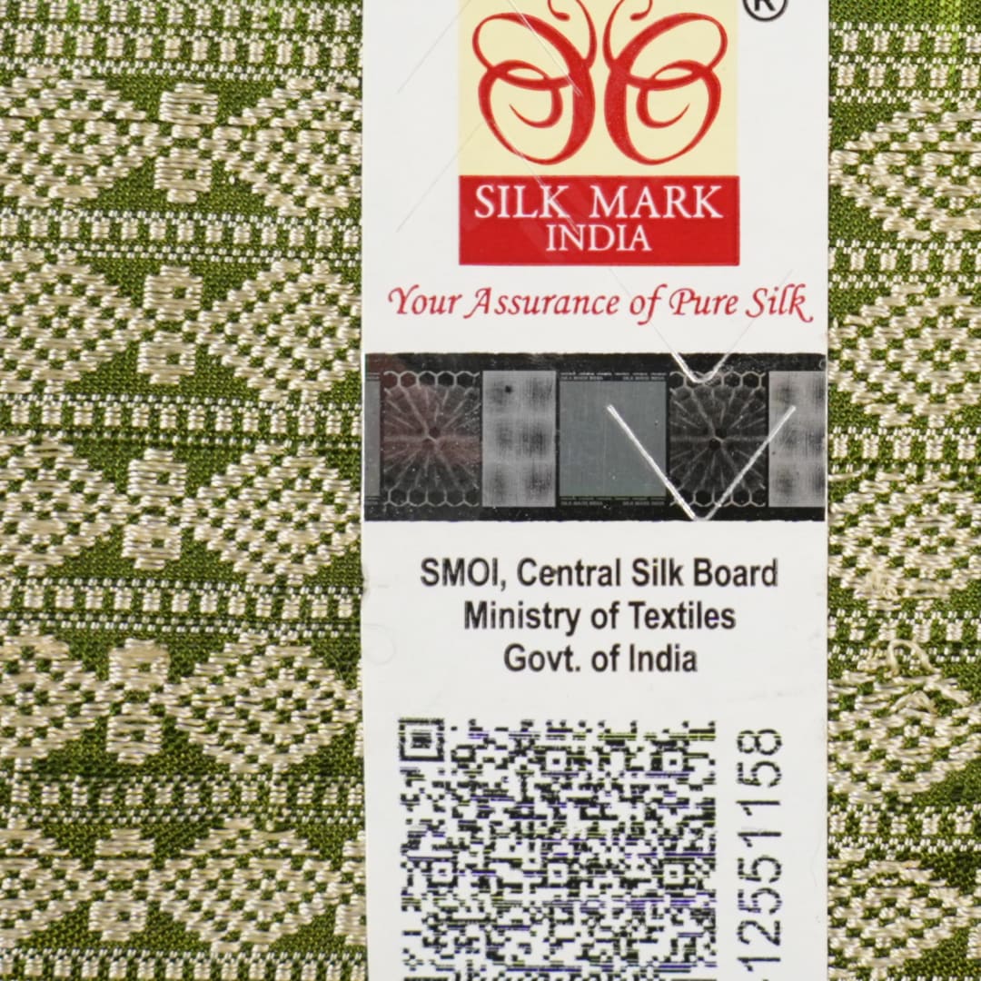 Close-up of the luxurious texture of the white Sambalpuri Silk Saree, revealing the fine weave and motif details.