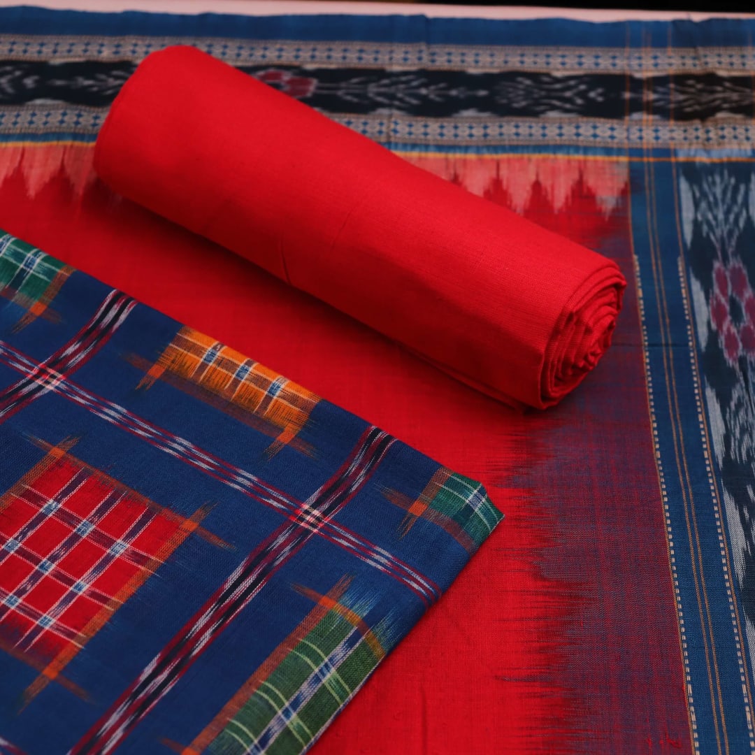 Close-up of off-white blouse piece with red motifs, paired with a Blue Sambalpuri cotton dress material.