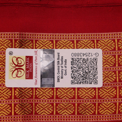 Close-up of white and red silk Bomkai saree fabric texture with butta pattern.