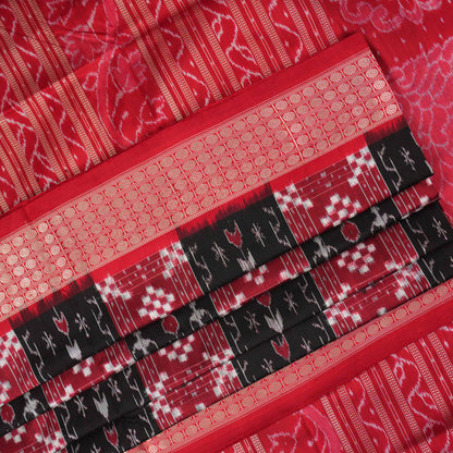 Close-up of the rich, smooth texture of the black Sambalpuri silk saree fabric.