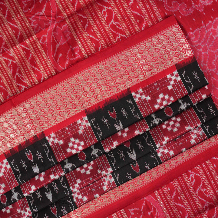 Close-up of the rich, smooth texture of the black Sambalpuri silk saree fabric.