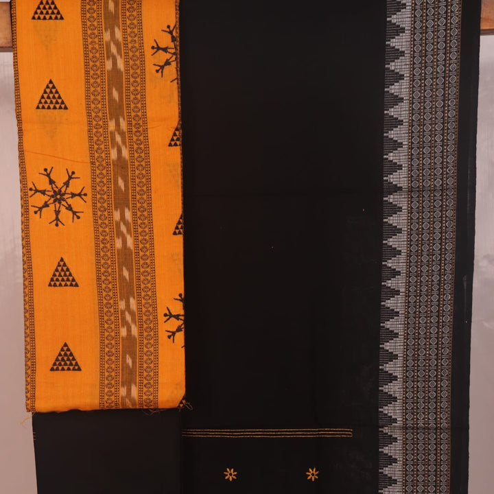 Close-up of yellow and black Sambalpuri cotton dress material blouse piece with motifs.