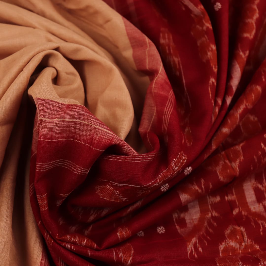 Cream-colored Sambalpuri cotton saree with maroon butta motifs, styled on a model