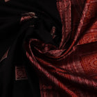Close-up of black and red silk Sambalpuri saree fabric showcasing intricate motifs