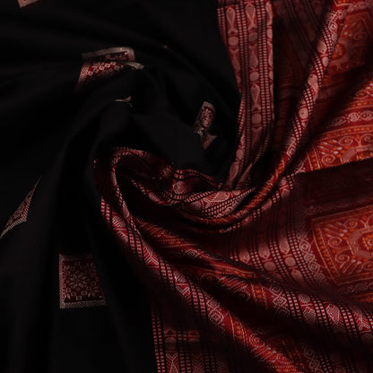 Close-up of black and red silk Sambalpuri saree fabric showcasing intricate motifs