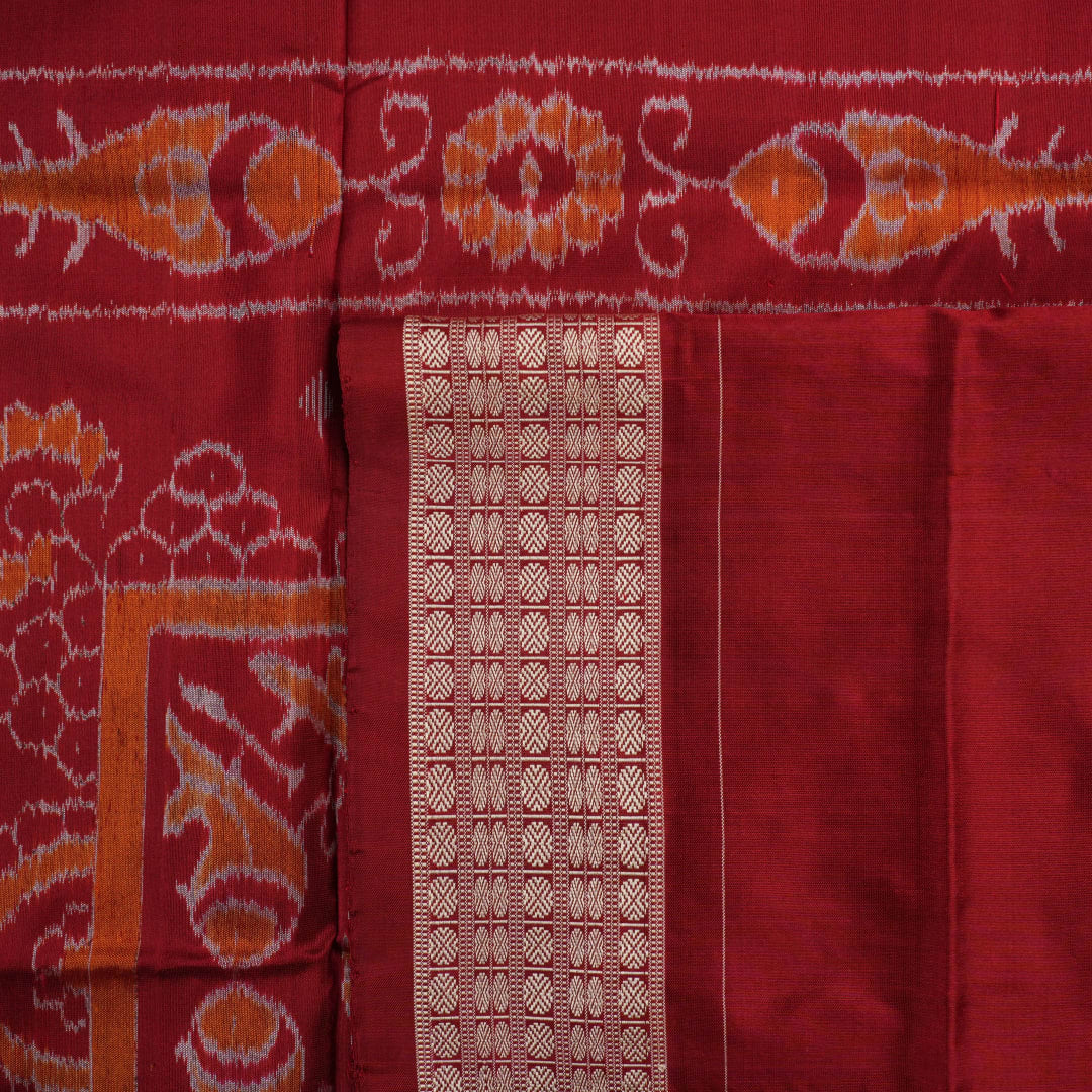 Close-up of Sambalpuri silk fabric texture, highlighting fine handloom weave in black and maroon.