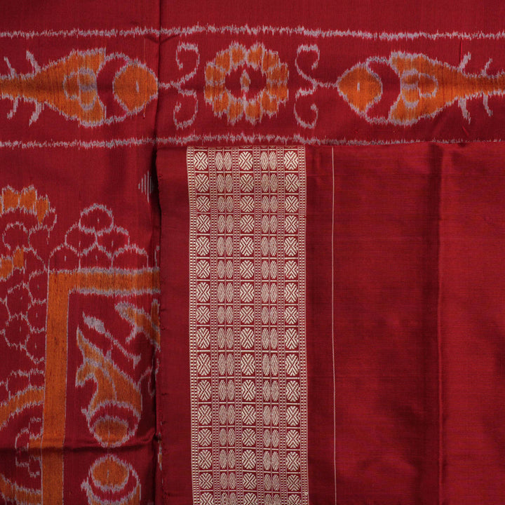 Close-up of Sambalpuri silk fabric texture, highlighting fine handloom weave in black and maroon.