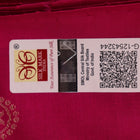 Close-up of green and magenta Bomkai silk saree fabric texture, highlighting intricate weave and butta pattern.
