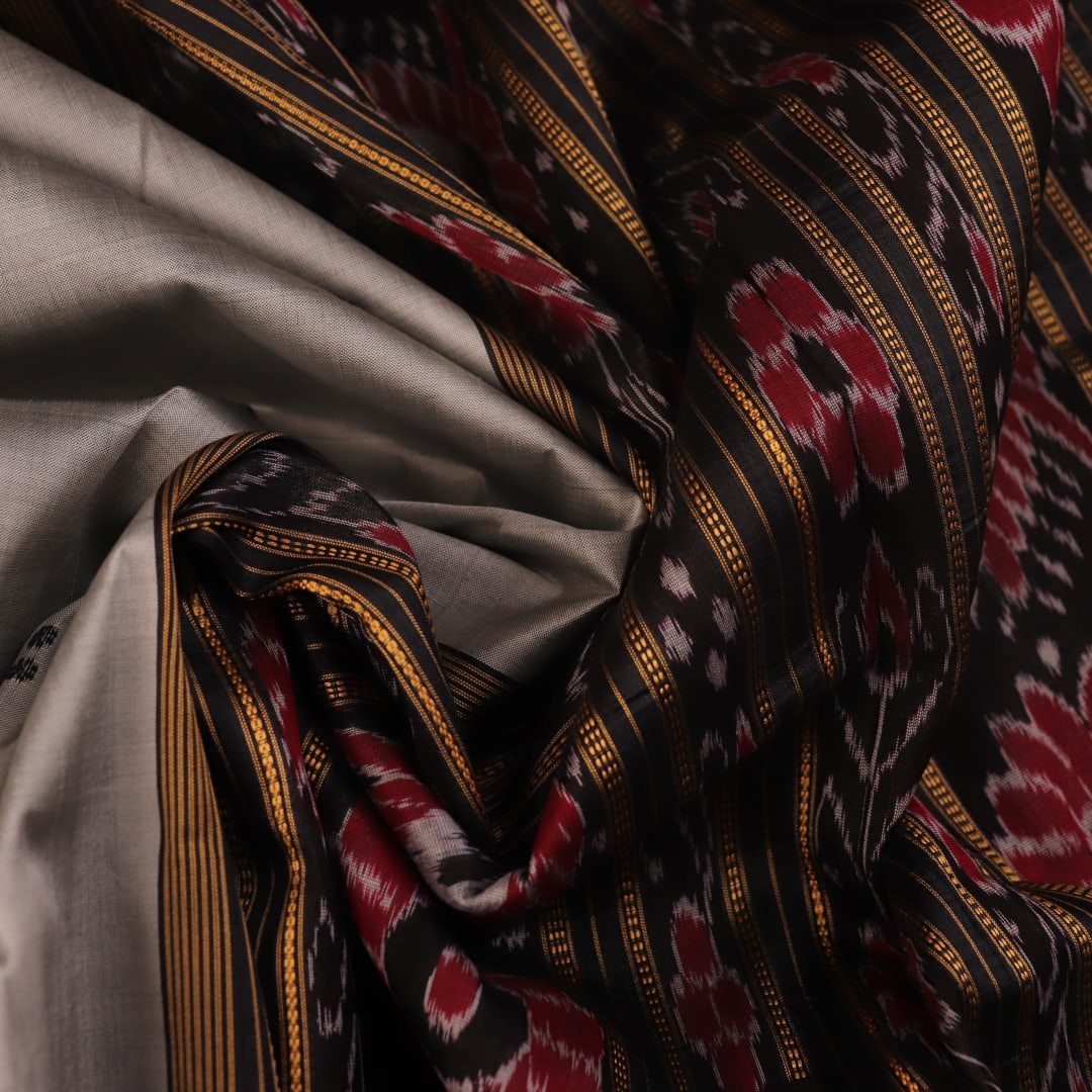 Saree draped: Grey Khandua silk saree with black butta pattern, showcasing elegant styling.