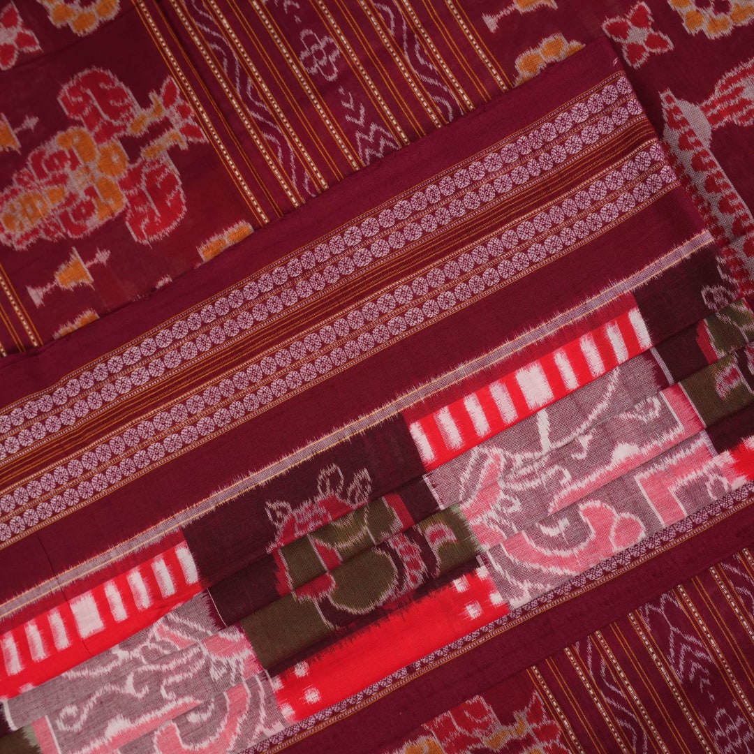 Model wearing a multi-color and maroon Sambalpuri cotton saree in a traditional Pasapalli weave
