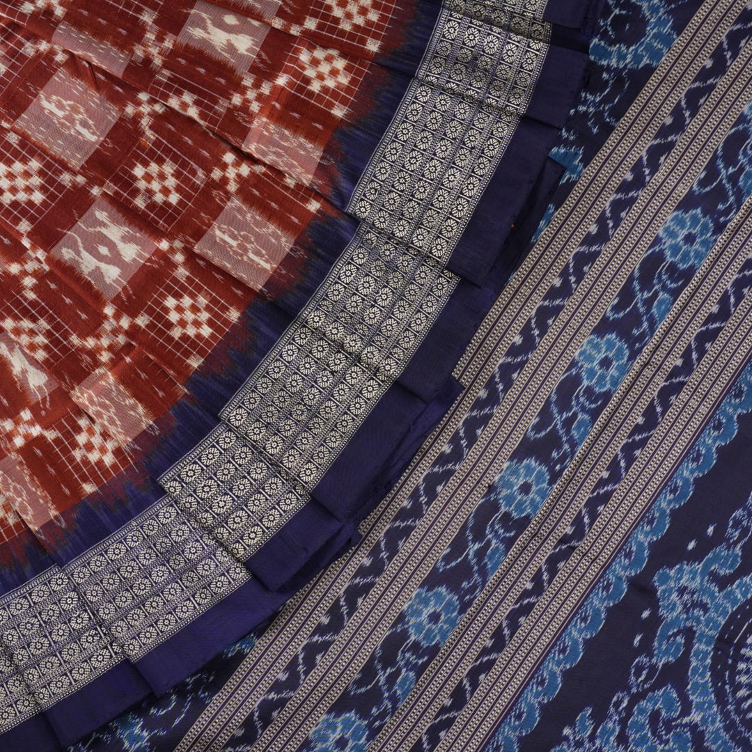 Close-up of the rich silk fabric texture of the Sambalpuri Saree, showing the intricate weave and slight sheen.