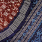 Close-up of the rich silk fabric texture of the Sambalpuri Saree, showing the intricate weave and slight sheen.