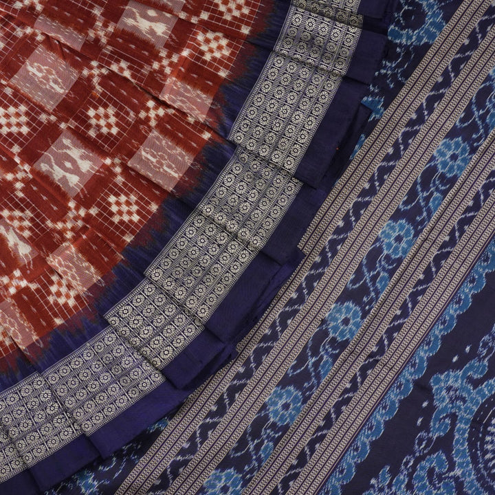 Close-up of the rich silk fabric texture of the Sambalpuri Saree, showing the intricate weave and slight sheen.
