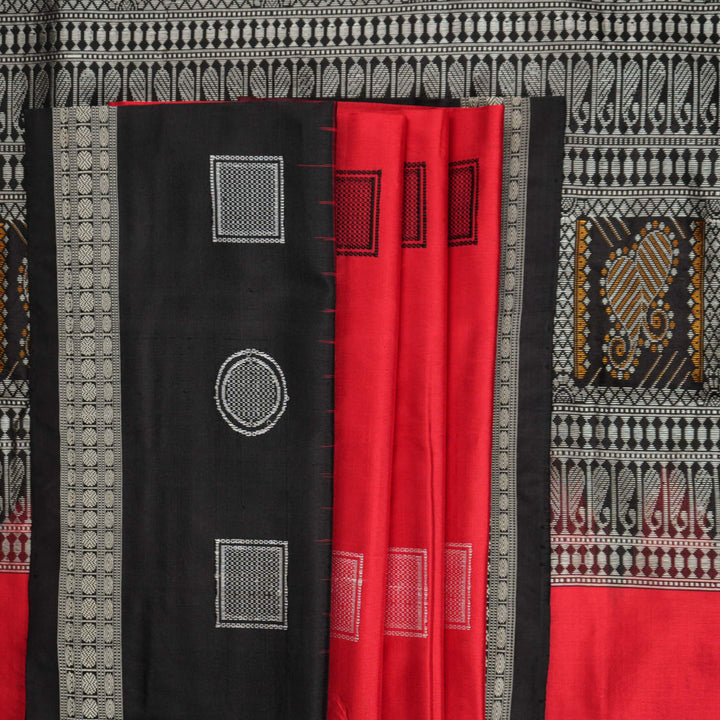 Extreme close-up of red Bomkai silk saree fabric showcasing rich texture and intricate weave.
