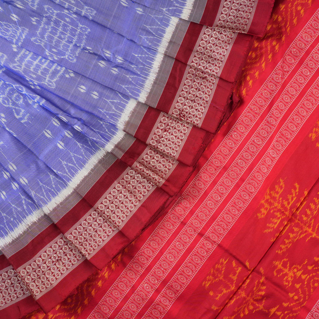 Close-up of the luxurious silk texture of the violet and maroon Sambalpuri Saree fabric.