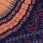 Cream cotton Bomkai saree with blue butta pattern, full view.