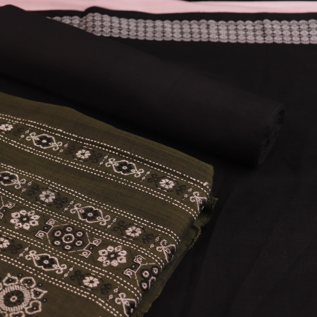 Detail of coordinating black Bomkai cotton blouse piece for green dress material.