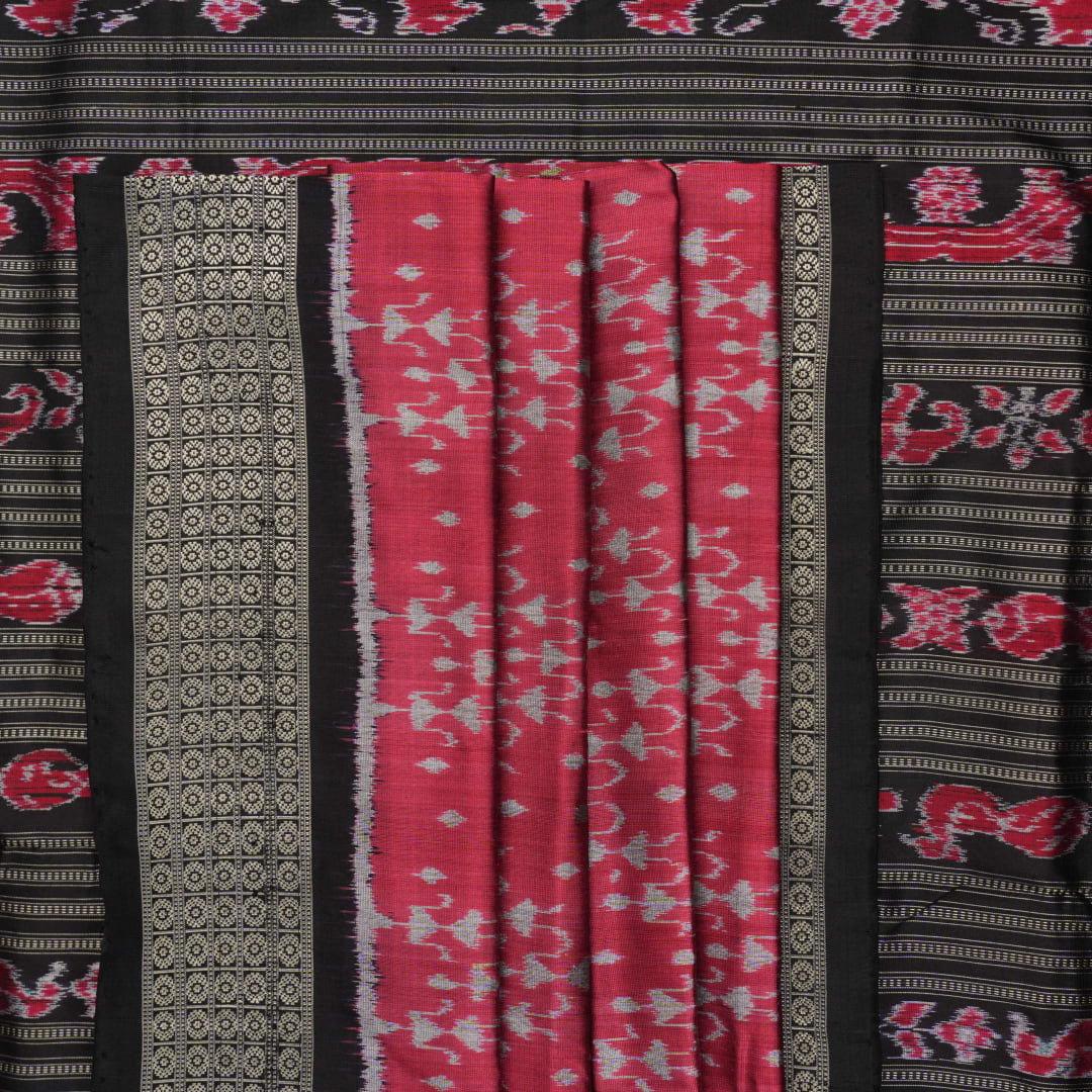 Detailed close-up of the maroon and black Sambalpuri silk saree's luxurious fabric texture and weave.