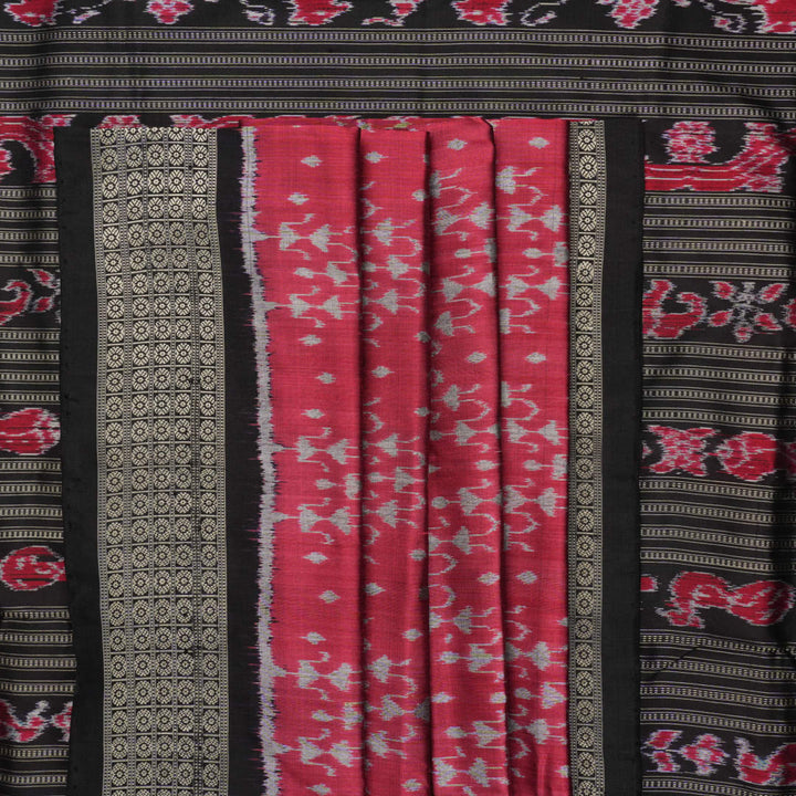 Detailed close-up of the maroon and black Sambalpuri silk saree's luxurious fabric texture and weave.