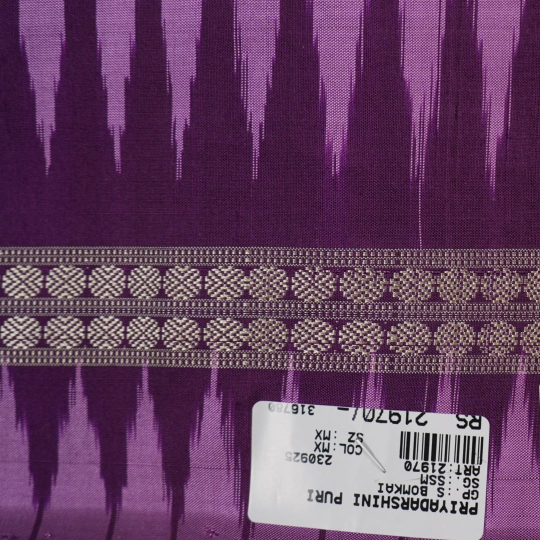 Close-up of purple Bomkai Silk Saree fabric, revealing its luxurious silk texture and exquisite handloom weave.