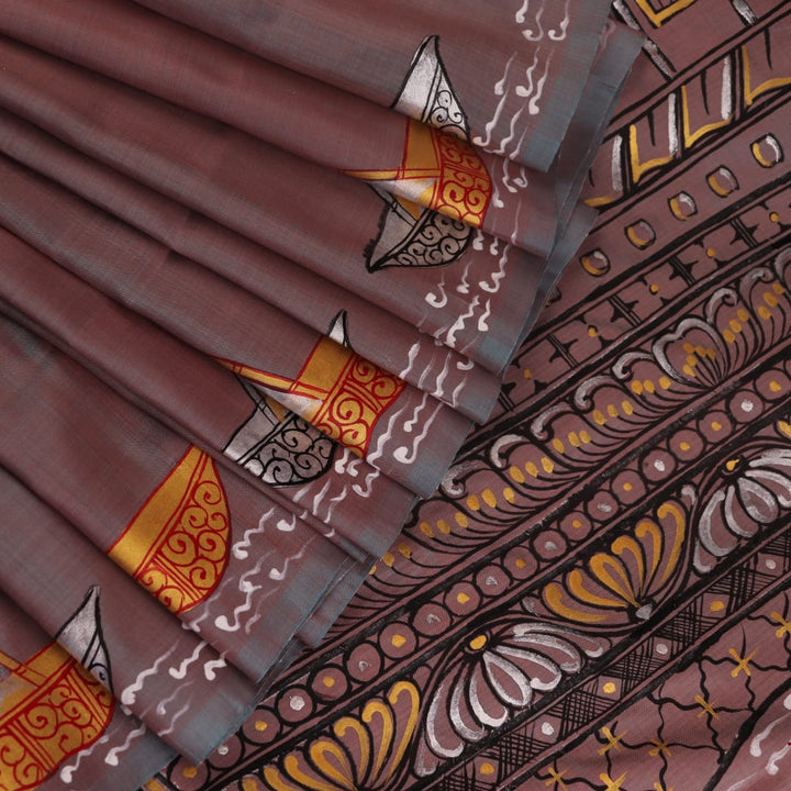Close-up of multicolored Patachitra silk saree fabric texture showing hand-painted details.