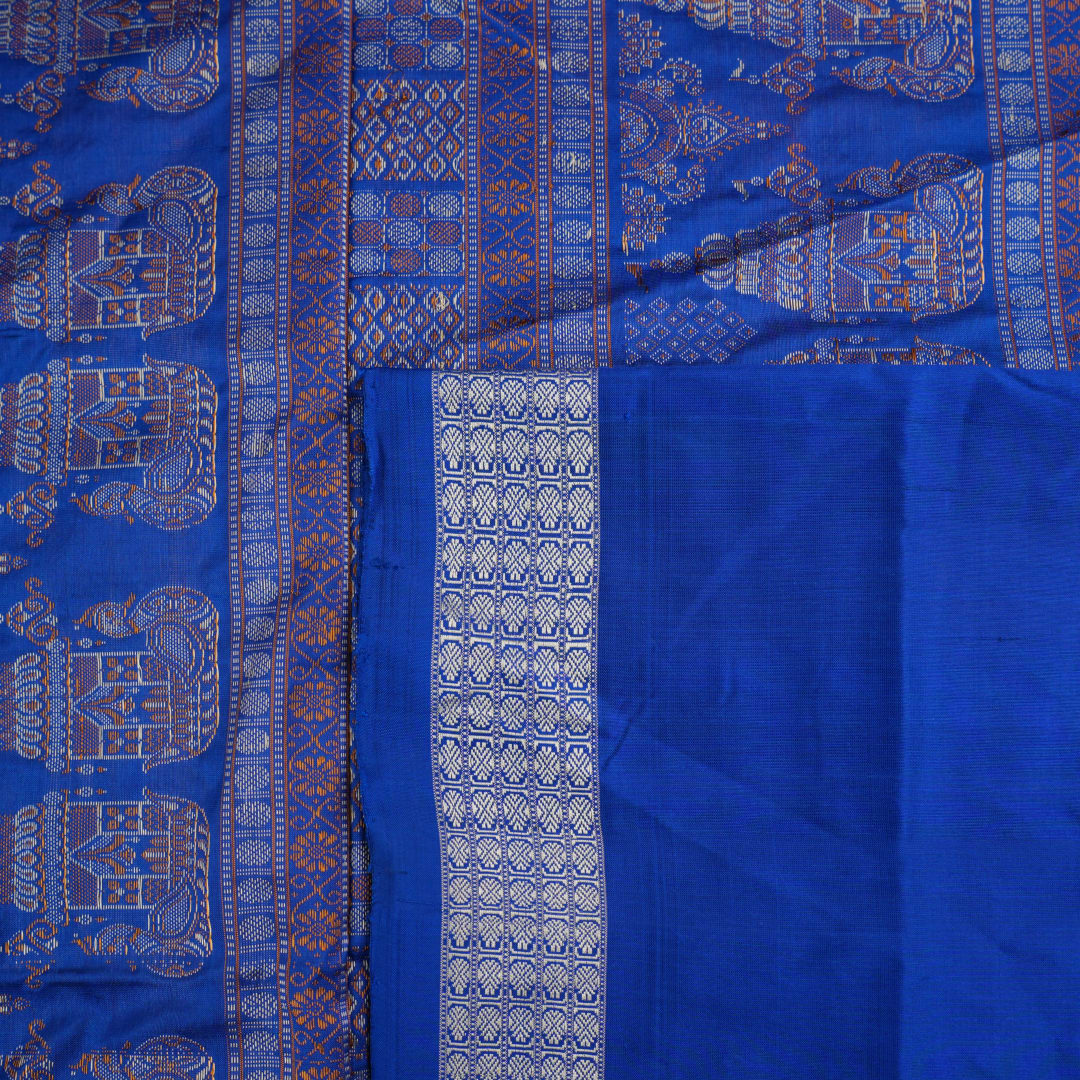 Close-up of Bomkai Silk Saree fabric texture and handloom weave in orange and blue threads.